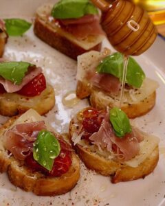 Tomato Garlic Confit Baguette with Asiago, Prosciutto, Basil, and Honey