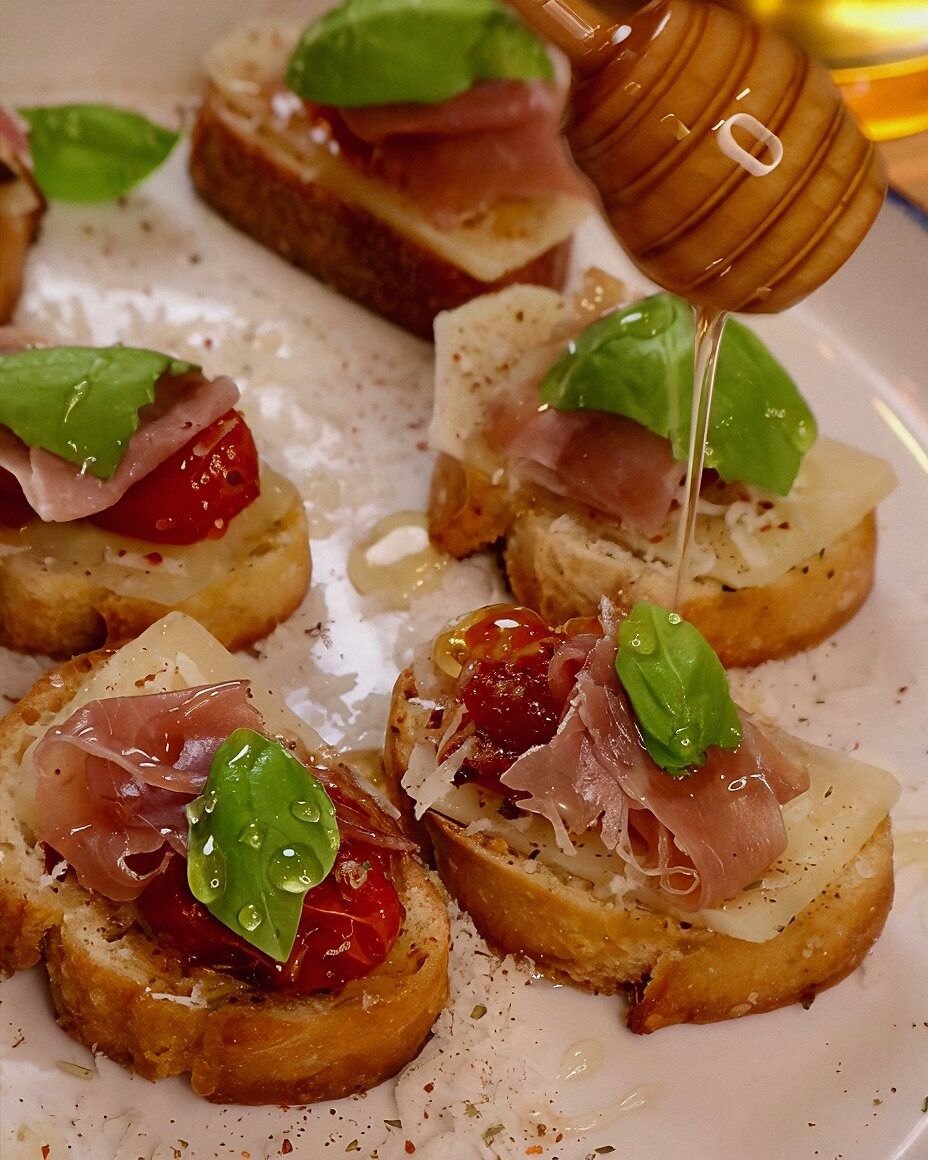 Tomato Garlic Confit Baguette with Asiago, Prosciutto, Basil, and Honey